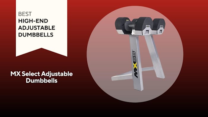 black mx fitness adjustable dumbbells on silver stand with black branding on red background